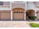 Close-up shot of garage doors in a townhome complex with brick driveway and well-maintained landscaping at 4235 Overture Cir # 4235, Bradenton, FL 34209
