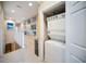 Upstairs hallway including laundry closet with stacked washer and dryer at 4235 Overture Cir # 4235, Bradenton, FL 34209