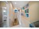 Bright hallway adorned with beach-themed artwork leading to bedrooms and other living spaces at 4235 Overture Cir # 4235, Bradenton, FL 34209