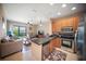 Open-concept living space featuring a kitchen with stainless steel appliances, and comfortable seating near a balcony at 4235 Overture Cir # 4235, Bradenton, FL 34209