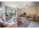 Open-concept living room flowing to the patio, offering a refreshing breeze and an abundance of natural light at 4235 Overture Cir # 4235, Bradenton, FL 34209