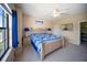 Comfortable bedroom with a king-sized bed, ceiling fan, and lots of natural light at 4235 Overture Cir # 4235, Bradenton, FL 34209