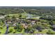 Aerial view of a residential community featuring lush greenery, well-maintained homes, and a small lake at 4333 Trails Dr # 10-1, Sarasota, FL 34232