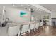 Resident clubhouse bar with granite counters, seating for five, and a view of the grounds at 4333 Trails Dr # 10-1, Sarasota, FL 34232