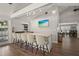 Stylish bar with counter seating, modern lighting, and a beach view TV in the clubhouse at 4333 Trails Dr # 10-1, Sarasota, FL 34232
