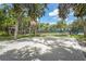 Community basketball court and tennis court with mature trees, and green space at 4333 Trails Dr # 10-1, Sarasota, FL 34232