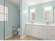 Bathroom featuring a double sink vanity, white cabinets, and a toilet at 4333 Trails Dr # 10-1, Sarasota, FL 34232