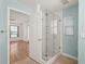 Bathroom featuring a glass shower and an open doorway to the bedroom at 4333 Trails Dr # 10-1, Sarasota, FL 34232