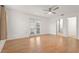 Bright bedroom featuring a ceiling fan, wood floors, and French doors leading to outdoor space at 4333 Trails Dr # 10-1, Sarasota, FL 34232