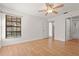Bright bedroom with ensuite bathroom access, hardwood floors and a ceiling fan at 4333 Trails Dr # 10-1, Sarasota, FL 34232