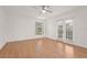 Sun-filled bedroom featuring hardwood floors, a ceiling fan, and sliding glass doors at 4333 Trails Dr # 10-1, Sarasota, FL 34232
