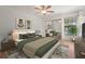 Bedroom featuring a bed, window, ceiling fan, and a closet with mirrored doors at 4333 Trails Dr # 10-1, Sarasota, FL 34232