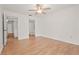 Bright bedroom with hardwood floors, ceiling fan, ensuite bathroom and closet access at 4333 Trails Dr # 10-1, Sarasota, FL 34232