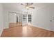Well-lit bedroom with mirrored closet doors, two windows, and wood flooring at 4333 Trails Dr # 10-1, Sarasota, FL 34232