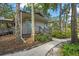 Community clubhouse with a sidewalk entrance surrounded by trees, adding to the neighborhood's charm at 4333 Trails Dr # 10-1, Sarasota, FL 34232
