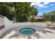 Cozy hot tub and spa area surrounded by lush greenery and a safety fence at 4333 Trails Dr # 10-1, Sarasota, FL 34232