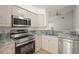 Kitchen features granite countertops, stainless steel appliances, and ample cabinetry at 4333 Trails Dr # 10-1, Sarasota, FL 34232