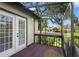 Enclosed lanai featuring wood flooring with access to exterior and interior doors at 4333 Trails Dr # 10-1, Sarasota, FL 34232