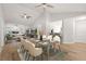 Open concept living and dining room with vaulted ceilings, hardwood floors and stylish furnishings at 4333 Trails Dr # 10-1, Sarasota, FL 34232