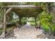 Inviting pergola seating area with brick pavers and two benches, offering a tranquil spot within the community at 4333 Trails Dr # 10-1, Sarasota, FL 34232
