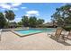 Community pool with lounge chairs, lush landscaping, and a secure perimeter fence at 4333 Trails Dr # 10-1, Sarasota, FL 34232