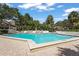 Inviting pool area with lounge chairs for relaxing and a lush green landscape at 4333 Trails Dr # 10-1, Sarasota, FL 34232