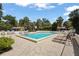 Community pool area with lounge chairs and a surrounding fence for added privacy at 4333 Trails Dr # 10-1, Sarasota, FL 34232
