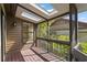 Screened porch with natural light streaming through skylights, overlooking lush greenery at 4333 Trails Dr # 10-1, Sarasota, FL 34232