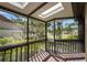 Screened-in porch featuring a skylight and views of lush greenery, offering a tranquil space at 4333 Trails Dr # 10-1, Sarasota, FL 34232