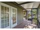 Charming porch featuring white French doors and screen, seamlessly blending indoor and outdoor living at 4333 Trails Dr # 10-1, Sarasota, FL 34232