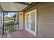 Inviting screened porch with wood flooring, double doors, and peaceful outdoor views at 4333 Trails Dr # 10-1, Sarasota, FL 34232