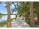 Picturesque waterfront walking path featuring lush greenery and benches perfect for relaxing by the water at 4333 Trails Dr # 10-1, Sarasota, FL 34232