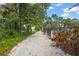 Beautiful walking path leads to the community pool with lush landscaping and mature trees at 4333 Trails Dr # 10-1, Sarasota, FL 34232
