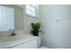 Small bathroom with a white vanity, toilet, and a simple mirror at 4374 Mirabella Cir, Bradenton, FL 34210
