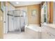 Bathroom featuring a glass shower and separate tub at 4374 Mirabella Cir, Bradenton, FL 34210