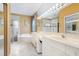 Bathroom featuring double sinks, vanity, and shower with glass doors at 4374 Mirabella Cir, Bradenton, FL 34210