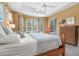 Bright bedroom featuring a tray ceiling, bay window seating area, and pool views at 4374 Mirabella Cir, Bradenton, FL 34210
