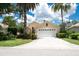 Charming home featuring a white garage door, tropical landscaping and a bright, sunny exterior at 4374 Mirabella Cir, Bradenton, FL 34210