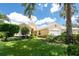Charming home featuring a white garage door, tropical landscaping and a bright, sunny exterior at 4374 Mirabella Cir, Bradenton, FL 34210
