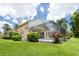 Back exterior showing screened-in pool and patio, and the surrounding landscaping at 4374 Mirabella Cir, Bradenton, FL 34210