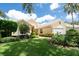 Inviting single-story home with lush landscaping, a well-maintained lawn, and a cozy, welcoming curb appeal at 4374 Mirabella Cir, Bradenton, FL 34210