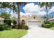 Charming single-story home with a well-manicured lawn, mature trees, and a two-car garage at 4374 Mirabella Cir, Bradenton, FL 34210