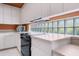 White kitchen with black appliances, tile backsplash, and ample counter space for meal preparation at 4374 Mirabella Cir, Bradenton, FL 34210