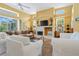 Bright and airy living room with high ceilings, fireplace, and access to the lanai at 4374 Mirabella Cir, Bradenton, FL 34210