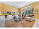Bright living room featuring tile floors, a ceiling fan, comfortable seating, and natural light from large windows at 4374 Mirabella Cir, Bradenton, FL 34210
