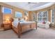 Relaxing main bedroom featuring a large bed, comfortable seating, and plenty of natural light at 4374 Mirabella Cir, Bradenton, FL 34210