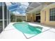 Screened pool with steps, surrounded by a large, white patio and seating area at 4374 Mirabella Cir, Bradenton, FL 34210