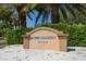 IMG Academy Golf Club sign surrounded by manicured bushes and palm trees, under a clear blue sky at 4374 Mirabella Cir, Bradenton, FL 34210
