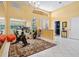 Bright workout room with exercise equipment, mirrors, a chandelier, and adjacent doorway at 4374 Mirabella Cir, Bradenton, FL 34210