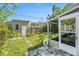 Backyard features an outdoor storage shed and enclosed sunroom with mature landscaping and a patio at 5028 Oxford N Ave, St Petersburg, FL 33710